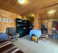 A cottage with a wooden decor floor, tiles, and comfortable furniture.