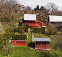 A cottage on Kavečianska Road in Košice, Sever district, surrounded by a garden and trees.
