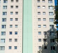 A building on Okružná Street in Trnava with multiple windows and a light facade.
