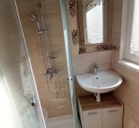 Bathroom with a shower and a sink in a 3-room apartment.
