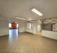 A space with tiled flooring, white walls, and lighting suitable for gastronomic use.