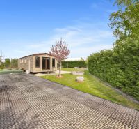 Cottage in Hurbanovo with a garden, paved path, and ornamental stones.