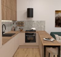 A kitchen in a 2-room apartment with a kitchen unit and a floor with a wooden decor.