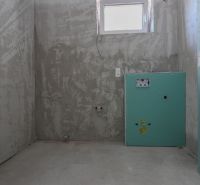 Unfinished bathroom in a 2-room apartment with a window and prepared installations.