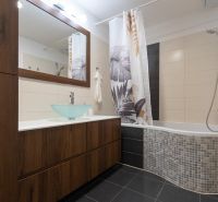 Bathroom in a 2-room apartment with a bathtub, sink, and tiled floor.