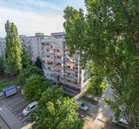 The view from a 2-room apartment on Tomášikova Street in Bratislava - Ružinov, trees and buildings.