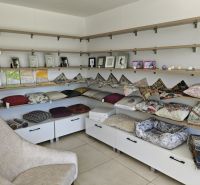 Retail spaces with decorative pillows, frames, and shelves.