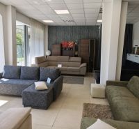Interior of commercial spaces with displayed sofas and built-in furniture.