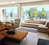 Bright commercial spaces with modern furniture and large windows.