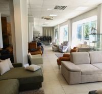 Comfortable sofas and armchairs in commercial spaces with large windows and fabric samples.