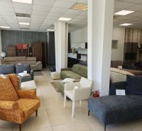 Commercial spaces filled with a variety of sofas and armchairs with white wall cladding.