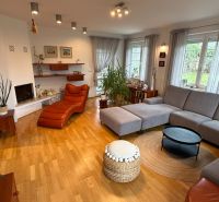 Living room in a family house with a comfortable corner sofa and a floor with a wood decor.