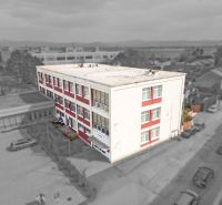 The building with red stripes on Jána Zigmundíka Street in the town of Vrbové, commercial premises.