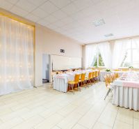 Commercial spaces with wood-patterned flooring, decorations, and tables with place settings.