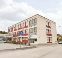 Building on Jána Zigmundíka Street in Vrbové, part commercial spaces with parking.