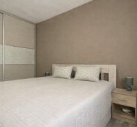 A bedroom with a large bed and a wardrobe in a 4-room apartment.