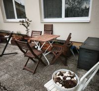 A terrace with wooden furniture at a 4-room apartment in Malá Lehota.