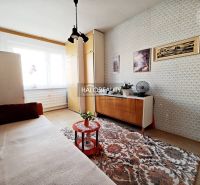Living room in a 2-room apartment with retro furniture and a carpet.
