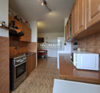 A kitchen in a 3-room apartment with wooden decor and appliances.