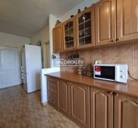 A kitchen in a 3-room apartment with built-in cabinets and a wooden decor floor.