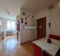 A kitchen in a 3-room apartment with tiles and a dining table.