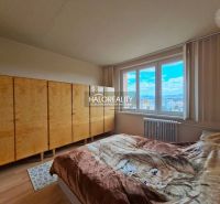 Bedroom with a bed and large wardrobes in a 3-room apartment.