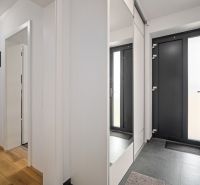 Interior of a family house with a wooden decor floor and glass doors.