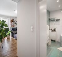 Interior of a family house with a wooden decor floor and a modern bathroom.