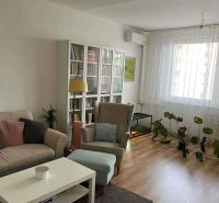 Living room in a 3-room apartment with comfortable furniture and a wooden decor floor.