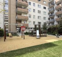 The courtyard on Galvaniho in Bratislava with a playground, slide, and swing near a 2-room apartment.