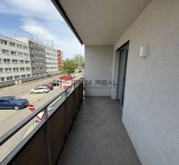 A balcony with a view of the parking lot and buildings on Galvaniho Street, Bratislava II.