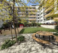 Playground and bench in the garden of the apartment complex on Galvaniho Street in Bratislava II.