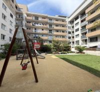 Courtyard with a children's playground surrounded by apartment buildings on Galvaniho in Bratislava II.