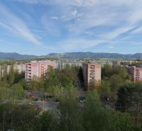 A view of the housing estate on Berlínska Street in Žilina with forests and mountains in the background.