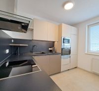 A kitchen in a 3-room apartment with a cooktop and light furnishings.
