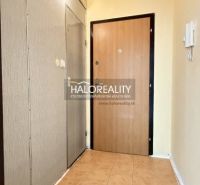 Studio apartment with tiled entrance hall, neutral walls, wooden door decor.