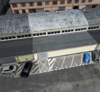 A top-down view of warehouses and halls on Coburgova Street in Trnava. A parking lot with cars.
