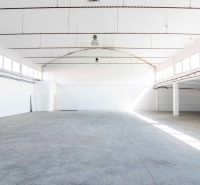 Spacious interior designed for warehouses and halls with a concrete floor and white walls.