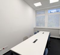Offices with a white desk and office chairs, with a large window in the room.