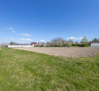 Plots - residential with grassy area in Dunakiliti, with visible houses in the background.