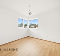 A bright room with windows and a wooden decor floor in a family house.