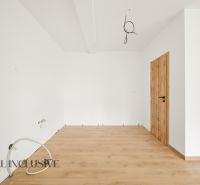 Interior of a family house with white walls and a wooden decor floor.