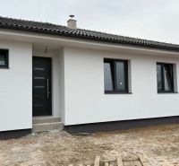 A family house in Michalovce on Hlavná Street with a white facade and black doors.
