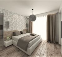 A bedroom in a family house with wooden flooring and patterned wallpaper.
