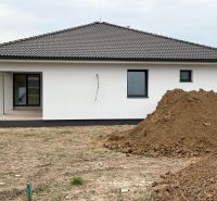 A family house on Hlavná Street in Michalovce, next to a pile of soil and a terrace.