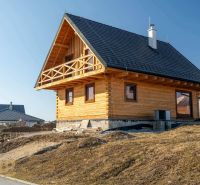 A family house in Stará Lesná with a wooden facade and a sloped roof.