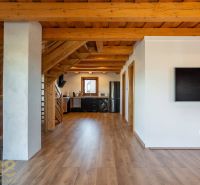 Interior of a family house with a kitchen, staircase, and wooden decor flooring.