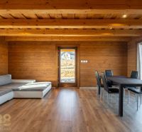 Living room in a family house with a wooden decor floor and a comfortable sofa set.