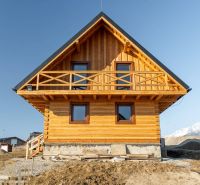 A family house in Stará Lesná with a wooden facade and a mountain backdrop.