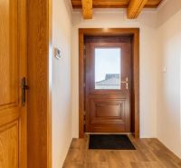 Interior doors in a family house with a wooden decor floor and visible beams.